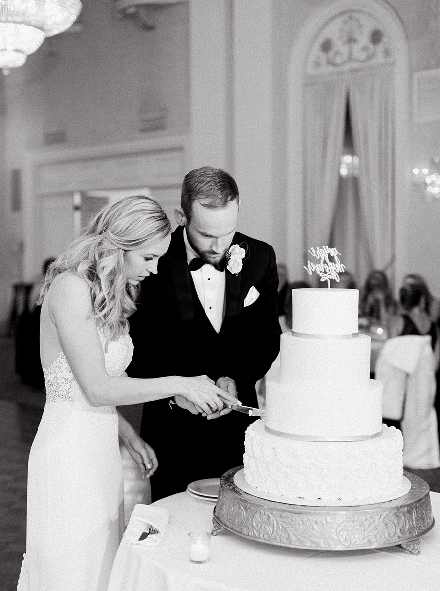 bride and groom cake cutting at milwaukee athletic club elegant classic wedding, blush bridesmaids and belle fiori flowers, romantic summer wedding, photo by laurelyn savannah photography