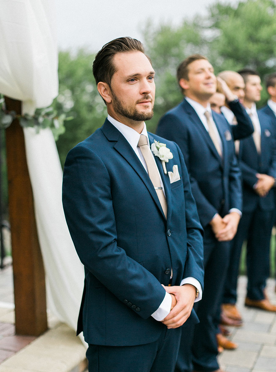 groom at ceremony, romantic and organic wedding at the ridge hotel in lake geneva, wisconsin, with elegant neutral colors, photo by laurelyn savannah photography 29