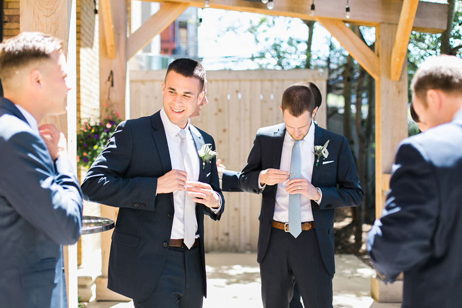 groom getting ready, Blue Watercolor-Inspired, elegant downtown modern wedding along the Milwaukee River in Wisconsin, photo by Laurelyn Savannah Photography 11