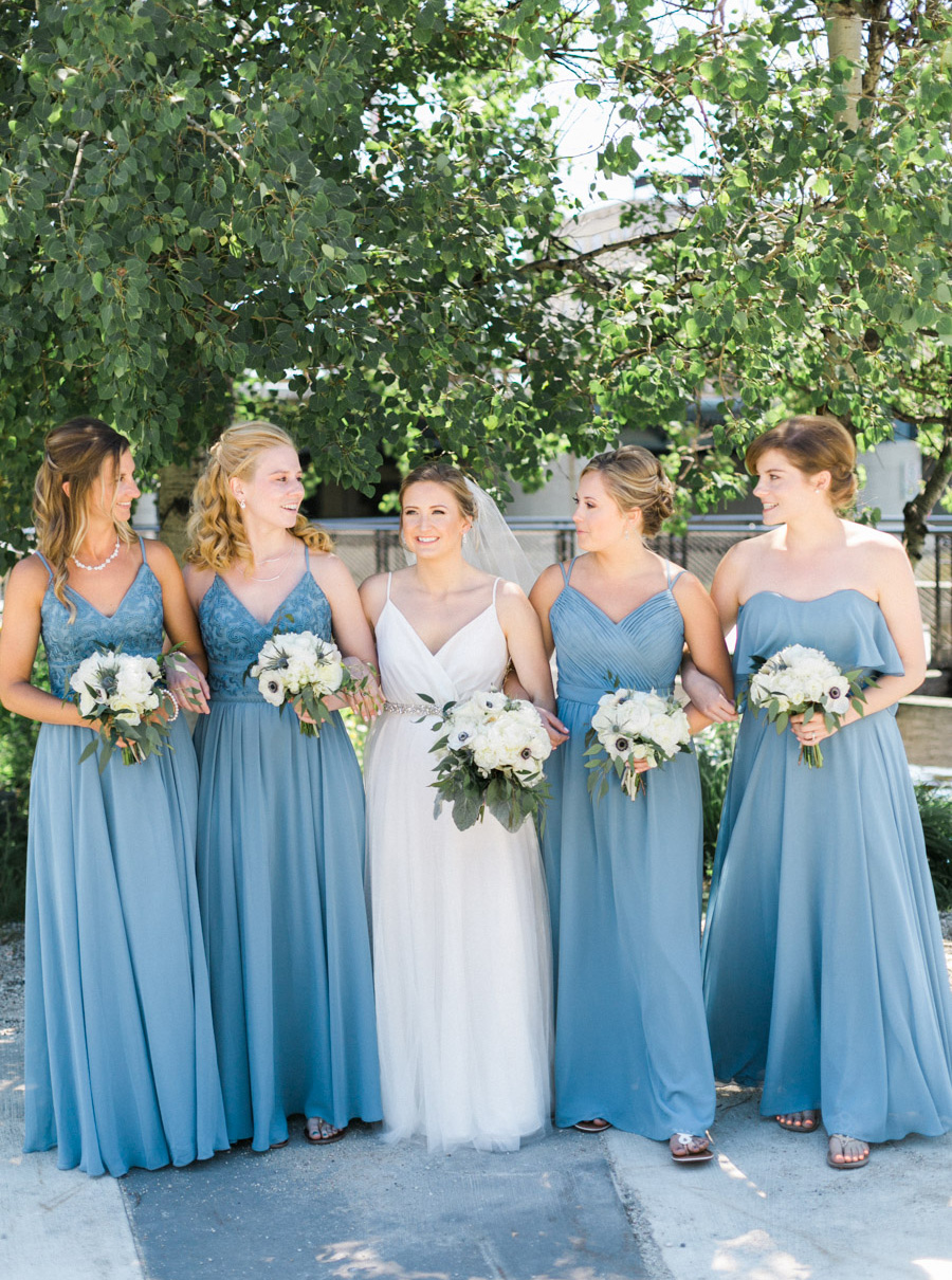 bride and bridesmaids, Blue Watercolor-Inspired, elegant downtown modern wedding along the Milwaukee River in Wisconsin, photo by Laurelyn Savannah Photography 12