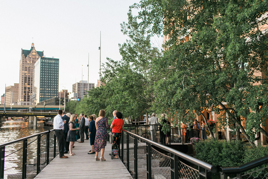 outdoor riverside cocktail hour, Blue Watercolor-Inspired, elegant downtown modern wedding along the Milwaukee River in Wisconsin, photo by Laurelyn Savannah Photography 32