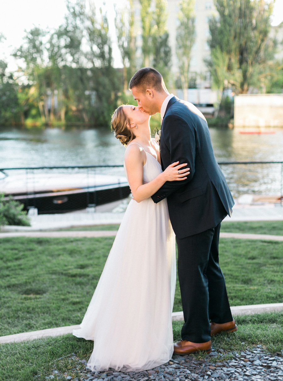 bride and groom sunset portrait, Blue Watercolor-Inspired, elegant downtown modern wedding along the Milwaukee River in Wisconsin, photo by Laurelyn Savannah Photography 33