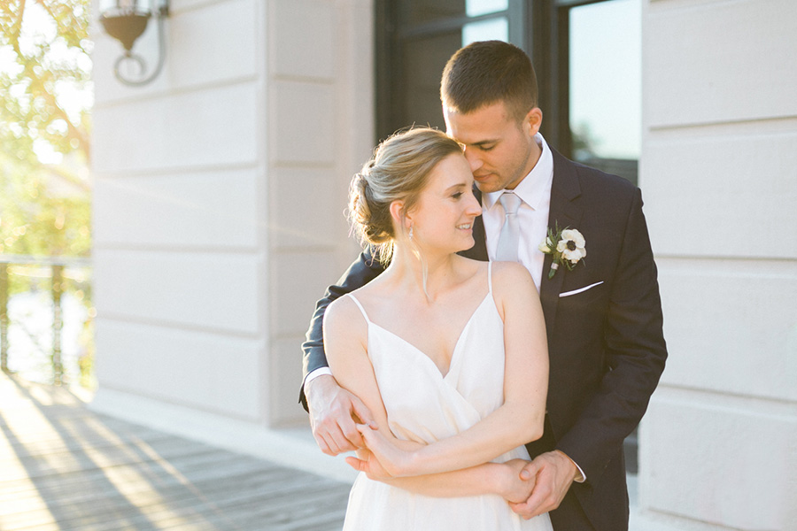 bride and groom sunset portrait, Blue Watercolor-Inspired, elegant downtown modern wedding along the Milwaukee River in Wisconsin, photo by Laurelyn Savannah Photography 51