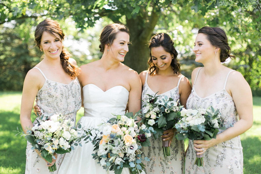 bride and bridesmaids, outdoor tented private estate wedding in a field in wisconsin, gold and blue colors, photo by laurelyn savannah photography 9