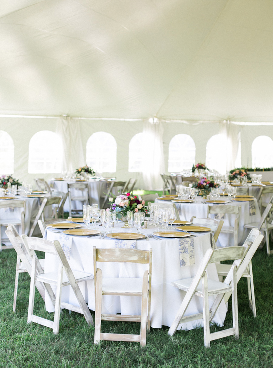 tented reception with gold wood chargers, outdoor tented private estate wedding in a field in wisconsin, gold and blue colors, photo by laurelyn savannah photography 18