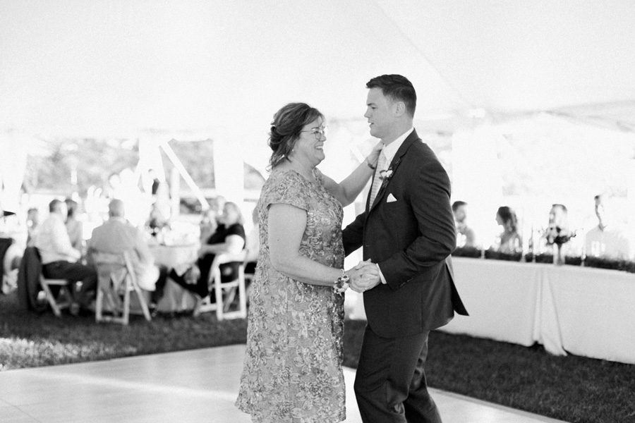 groom and mother dance, outdoor tented private estate wedding in a field in wisconsin, gold and blue colors, photo by laurelyn savannah photography 40
