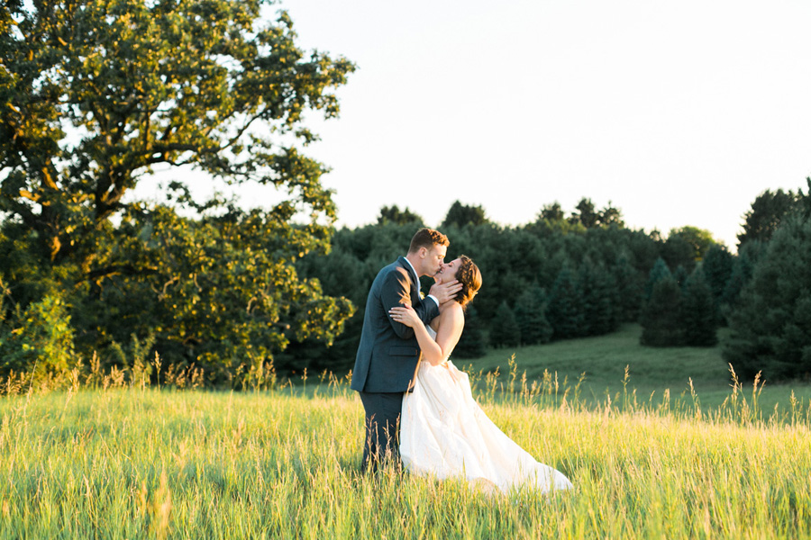 bride and groom sunset portraits, outdoor tented private estate wedding in a field in wisconsin, gold and blue colors, photo by laurelyn savannah photography 42