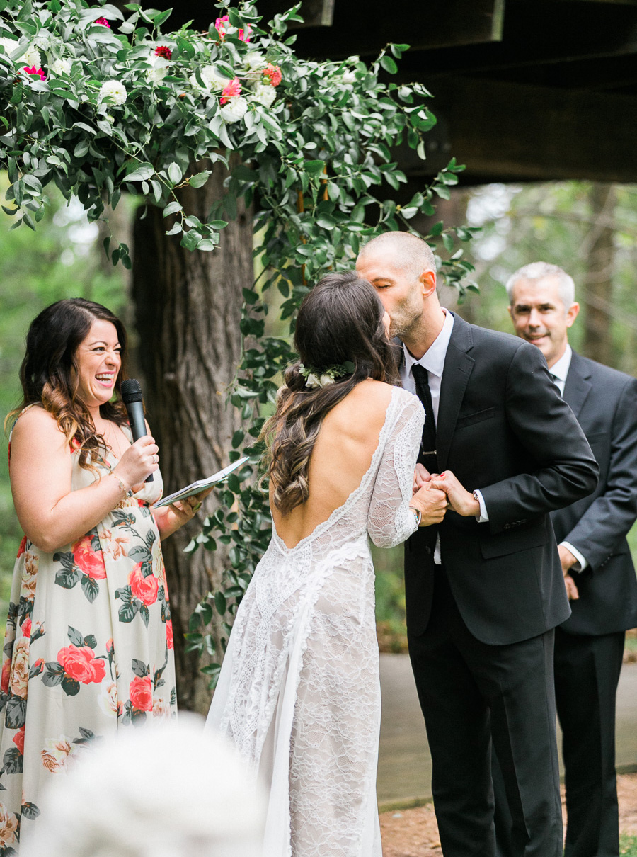 ceremony kiss at a boho outdoor wedding at Schlitz Audubon Nature Center in Milwaukee, Wisconsin, photo by Laurelyn Savannah Photography 53