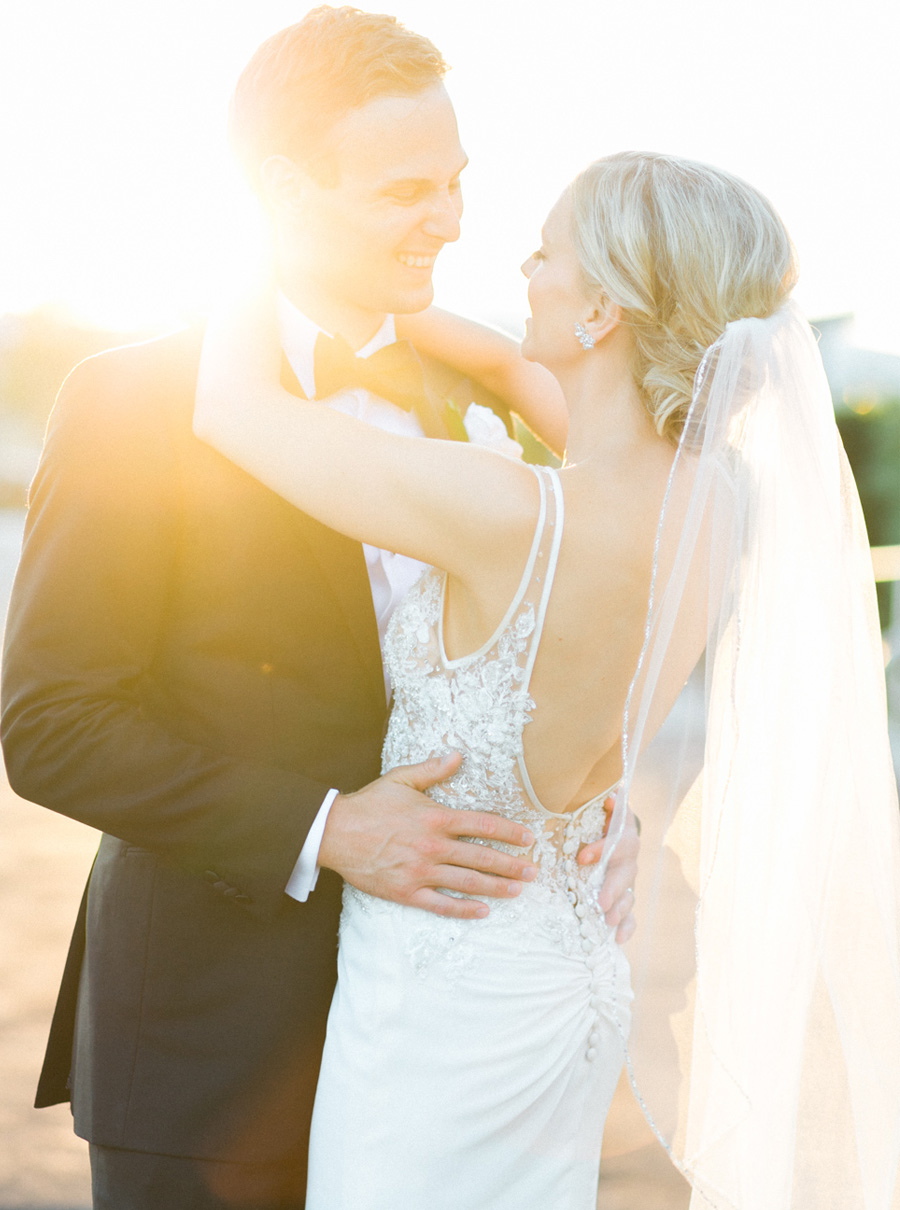 bride and groom sunset portrait, classic and romantic black tie and gold wedding in downtown Green Bay, Wisconsin, photo by Laurelyn Savannah Photography