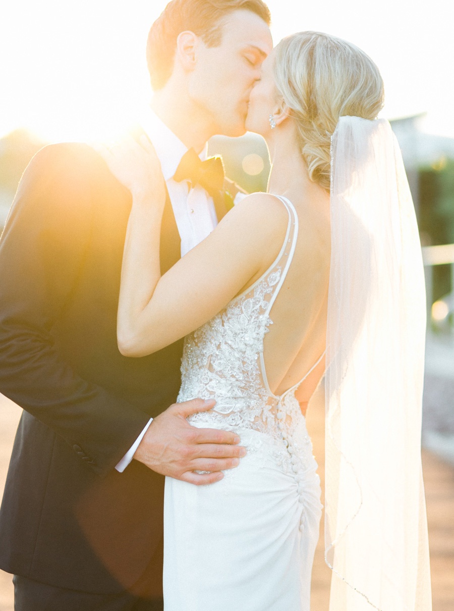 bride and groom sunset portrait, classic and romantic black tie and gold wedding in downtown Green Bay, Wisconsin, photo by Laurelyn Savannah Photography