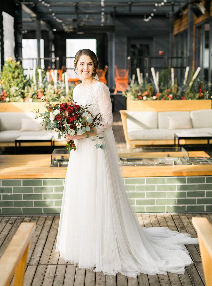 bride and groom portrait at kimpton journeyman hotel, classic, romantic gold and burgundy red winter wedding in downtown Milwaukee, Wisconsin, photo by Laurelyn Savannah Photography