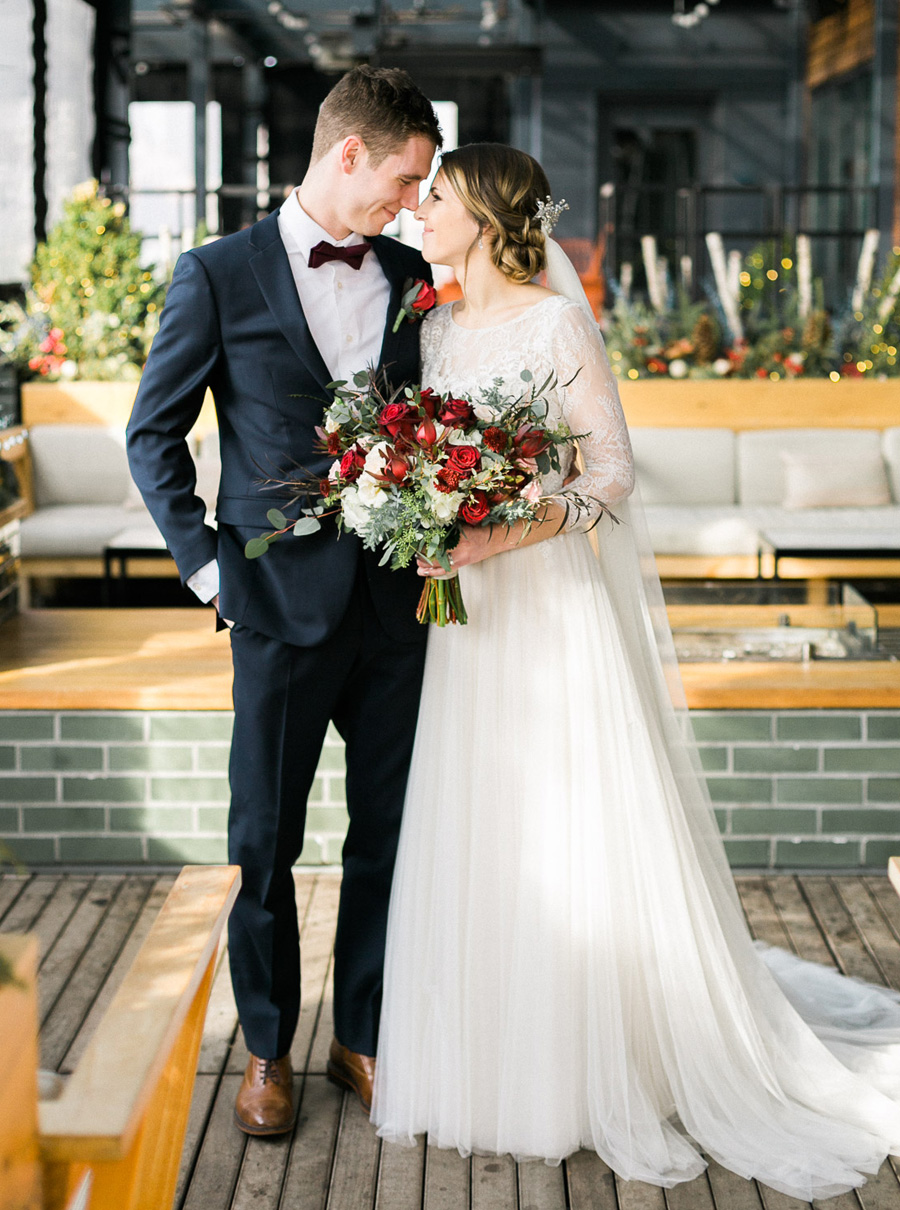 bride and groom portrait at kimpton journeyman hotel, classic, romantic gold and burgundy red winter wedding in downtown Milwaukee, Wisconsin, photo by Laurelyn Savannah Photography