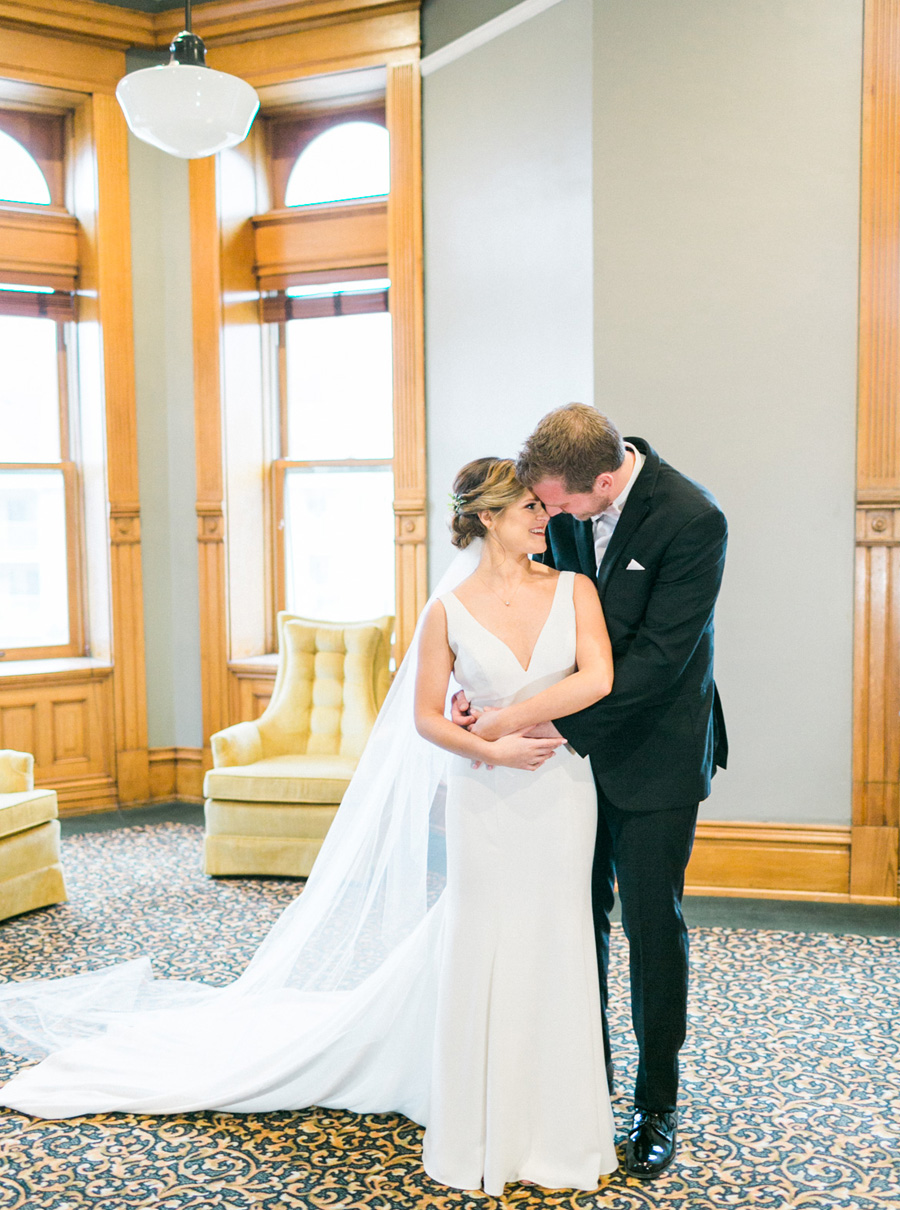first look, elegant green and gold fall wedding at Historic Courthouse 1893 in Waukesha Milwaukee, Wisconsin, photo by Laurelyn Savannah Photography