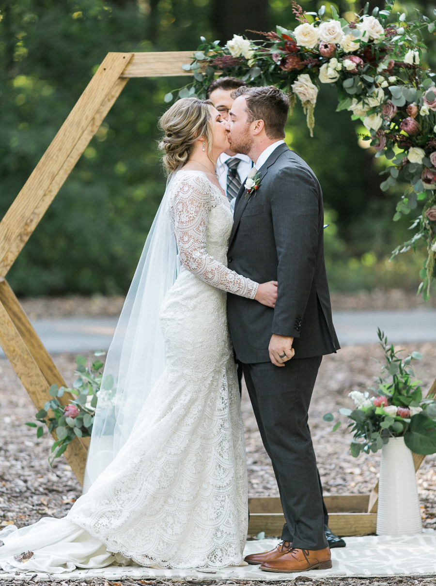 ceremony first kiss, glamping and chic safari romantic outdoor wedding at Milwaukee County Zoo, Wisconsin, photo by Laurelyn Savannah Photography