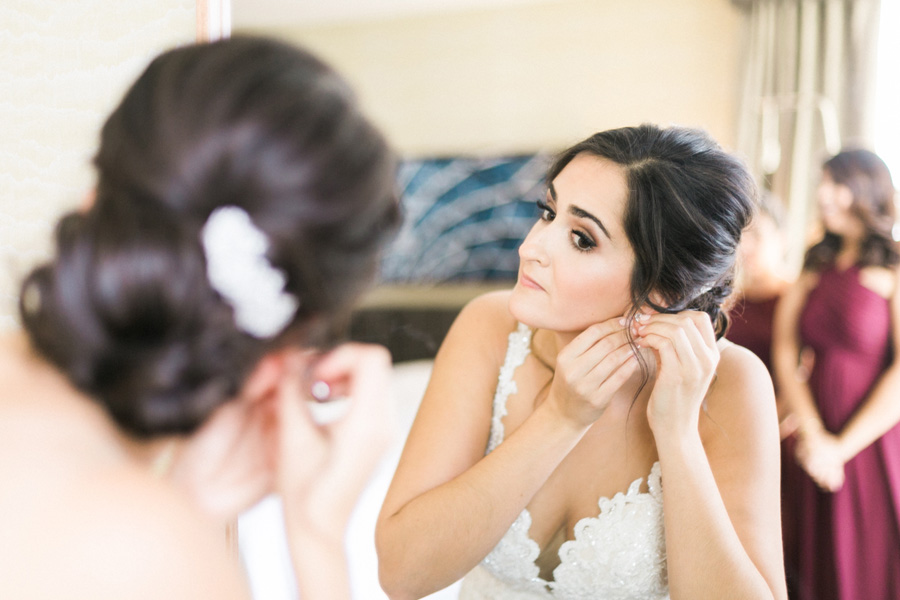 bride getting ready, romantic navy and gold and burgundy red fall wedding at Discovery World in downtown Milwaukee, Wisconsin, photo by Laurelyn Savannah Photography