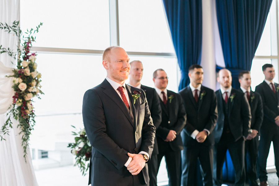 ceremony, romantic navy and gold and burgundy red fall wedding at Discovery World in downtown Milwaukee, Wisconsin, photo by Laurelyn Savannah Photography
