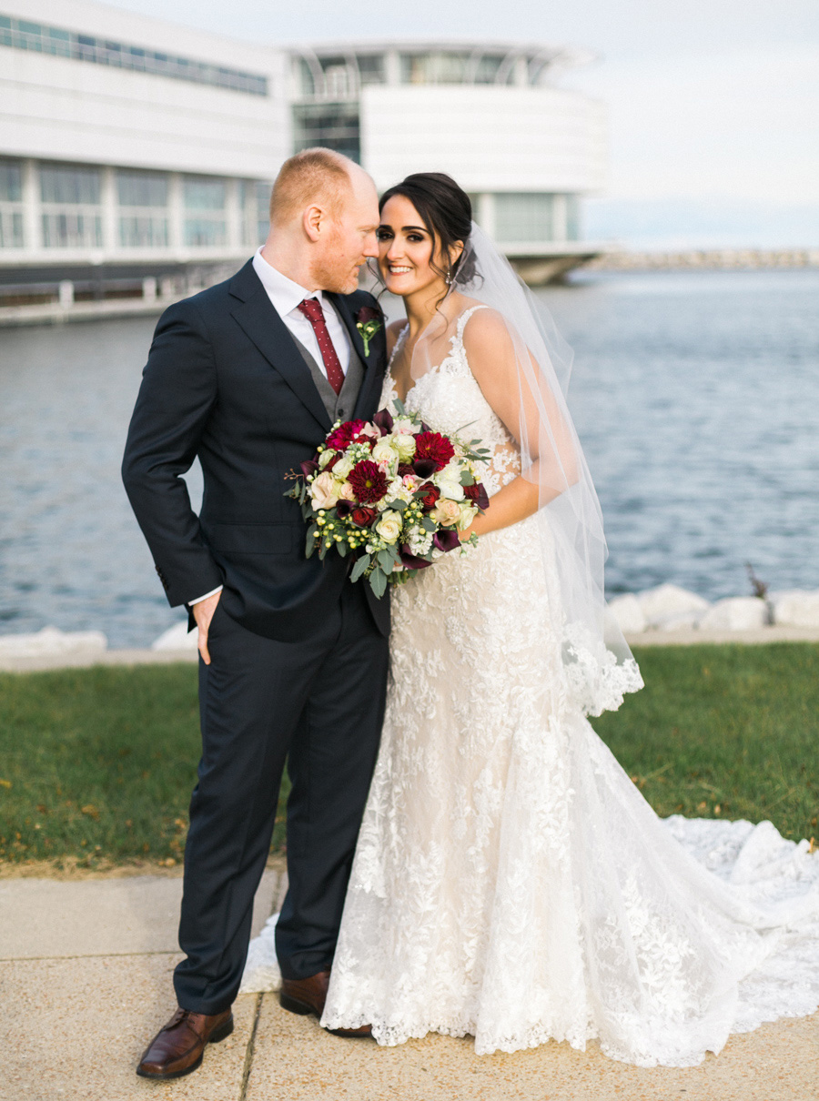 bride and groom portrait, romantic navy and gold and burgundy red fall wedding at Discovery World in downtown Milwaukee, Wisconsin, photo by Laurelyn Savannah Photography