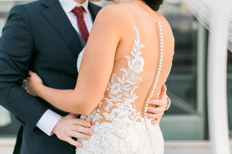 bride and groom sunset portrait, romantic navy and gold and burgundy red fall wedding at Discovery World in downtown Milwaukee, Wisconsin, photo by Laurelyn Savannah Photography