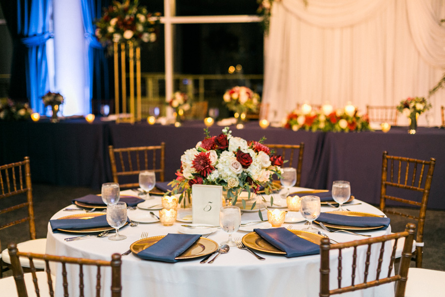 reception table decor, romantic navy and gold and burgundy red fall wedding at Discovery World in downtown Milwaukee, Wisconsin, photo by Laurelyn Savannah Photography