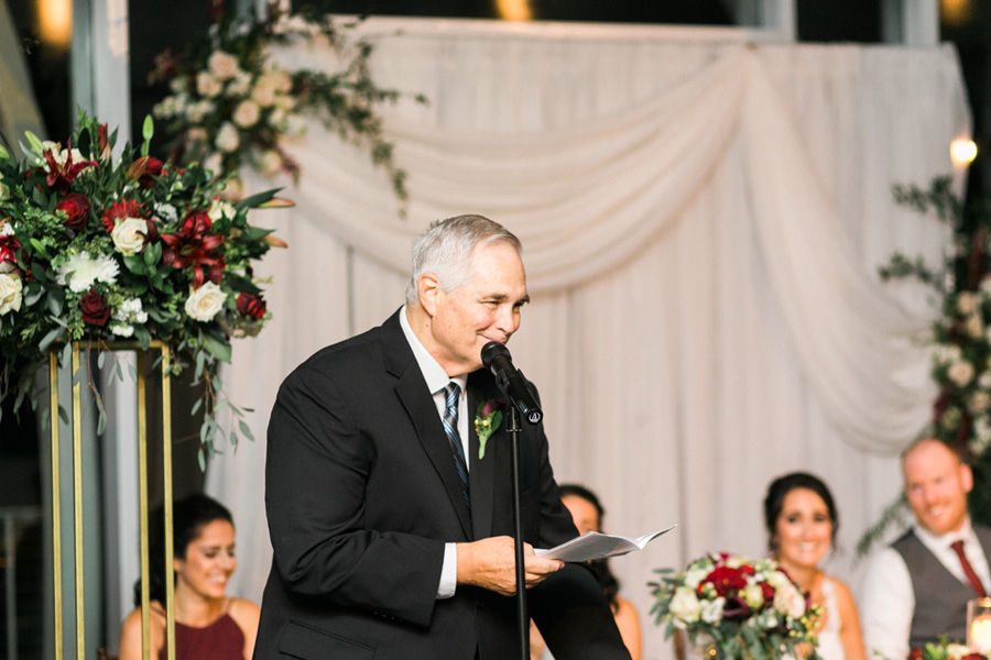 reception speech toast, romantic navy and gold and burgundy red fall wedding at Discovery World in downtown Milwaukee, Wisconsin, photo by Laurelyn Savannah Photography