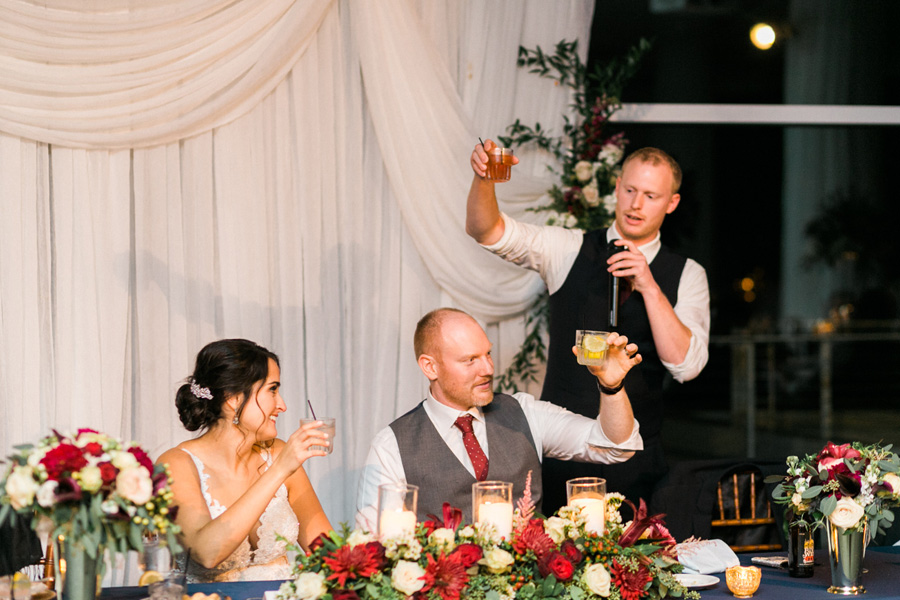 reception speech toast, romantic navy and gold and burgundy red fall wedding at Discovery World in downtown Milwaukee, Wisconsin, photo by Laurelyn Savannah Photography