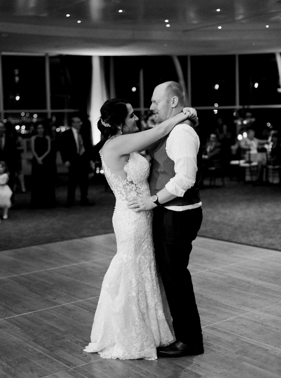 first dance, romantic navy and gold and burgundy red fall wedding at Discovery World in downtown Milwaukee, Wisconsin, photo by Laurelyn Savannah Photography