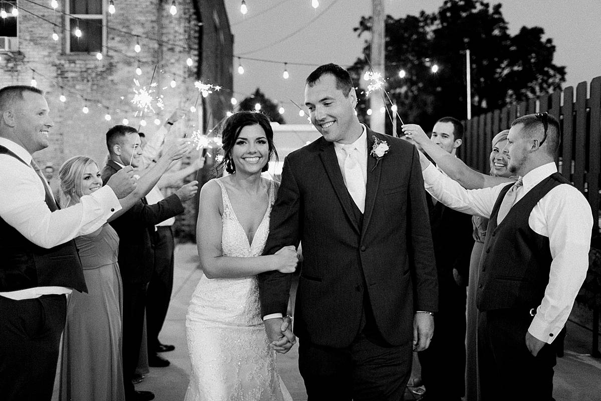 bride and groom sparkler exit, romantic lavender wisconsin wedding at mercantile hall, photo by laurelyn savannah photography