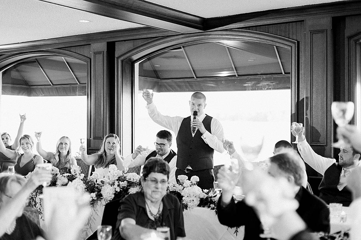 reception toast, classic lakeside wisconsin wedding at oconomowoc lake club, photo by laurelyn savannah photography