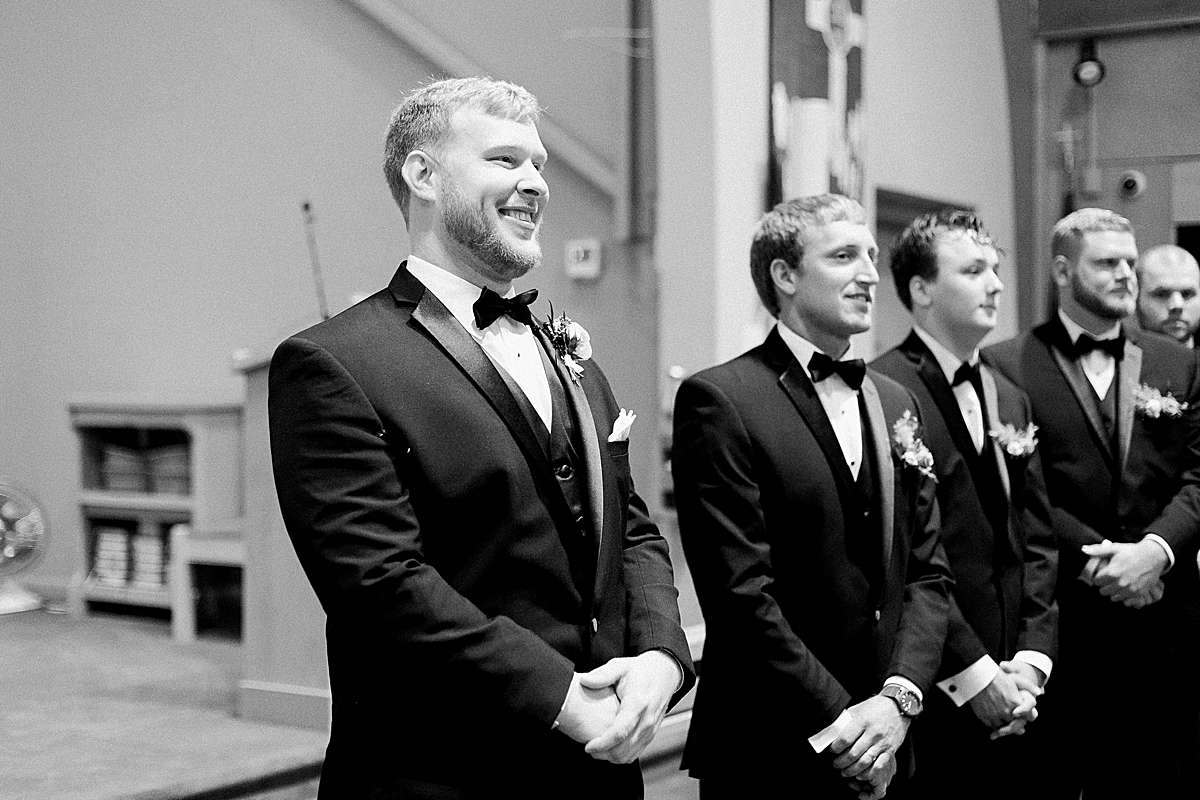 groom at ceremony, romantic wisconsin wedding at sentry world stevens point, photo by laurelyn savannah photography
