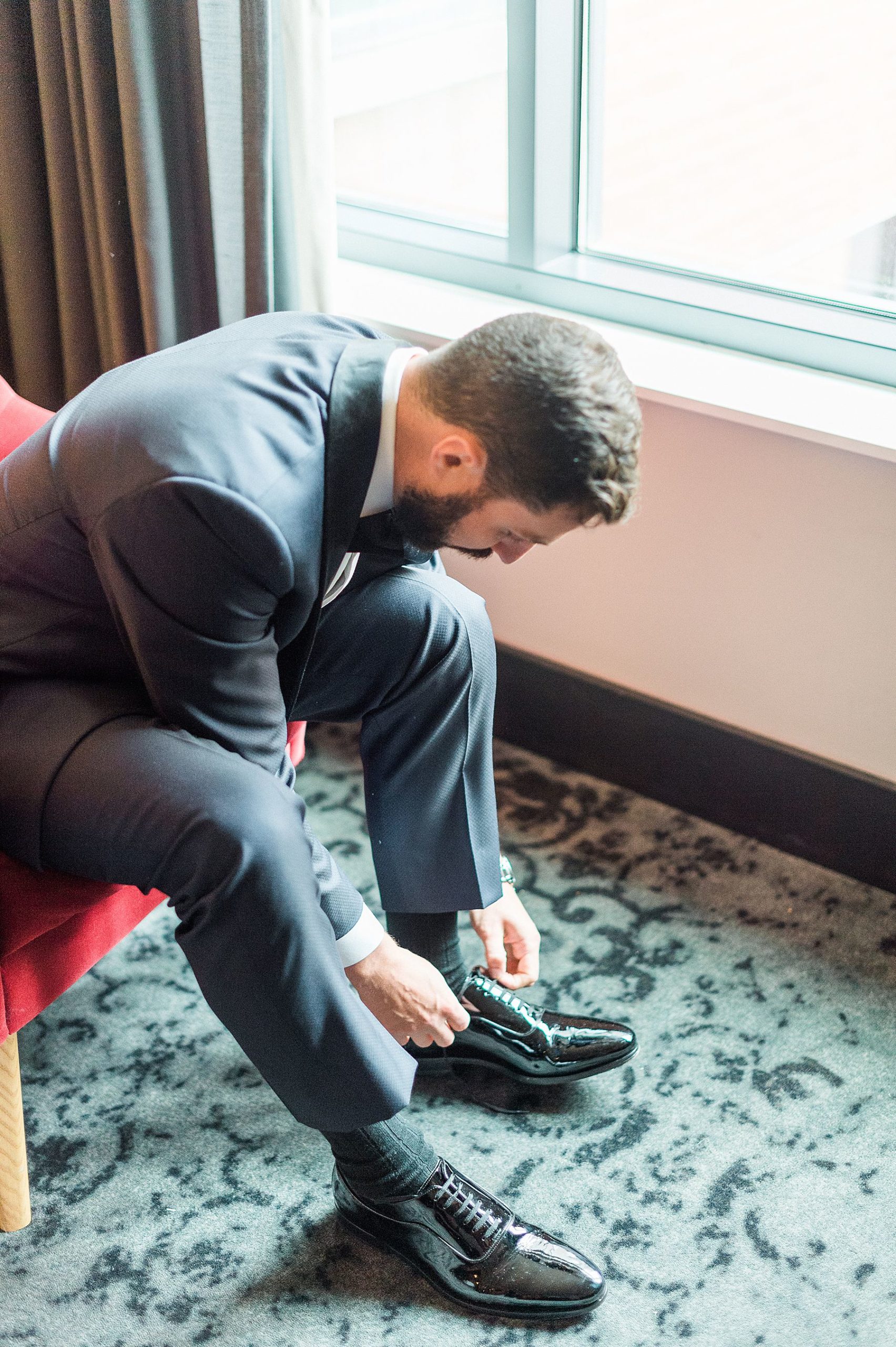 groom getting ready tying his shoes