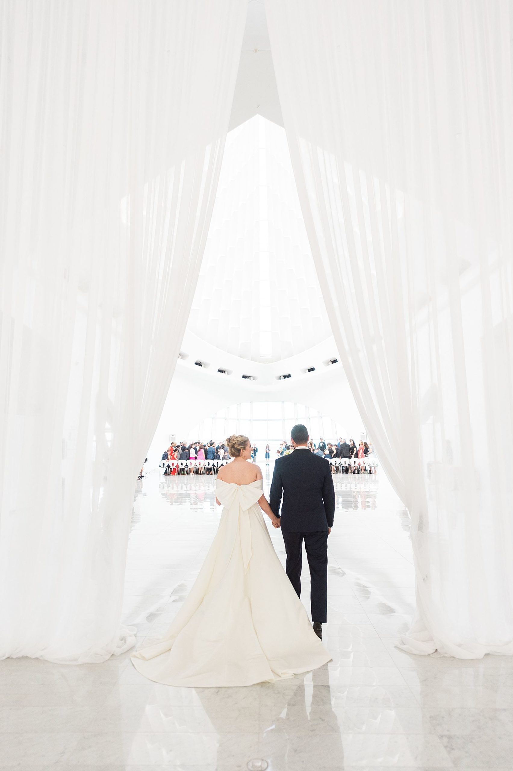 couple entrance, modern minimal white and bright wedding ceremony at milwaukee art museum an architectural gem downtown with lake michigan view