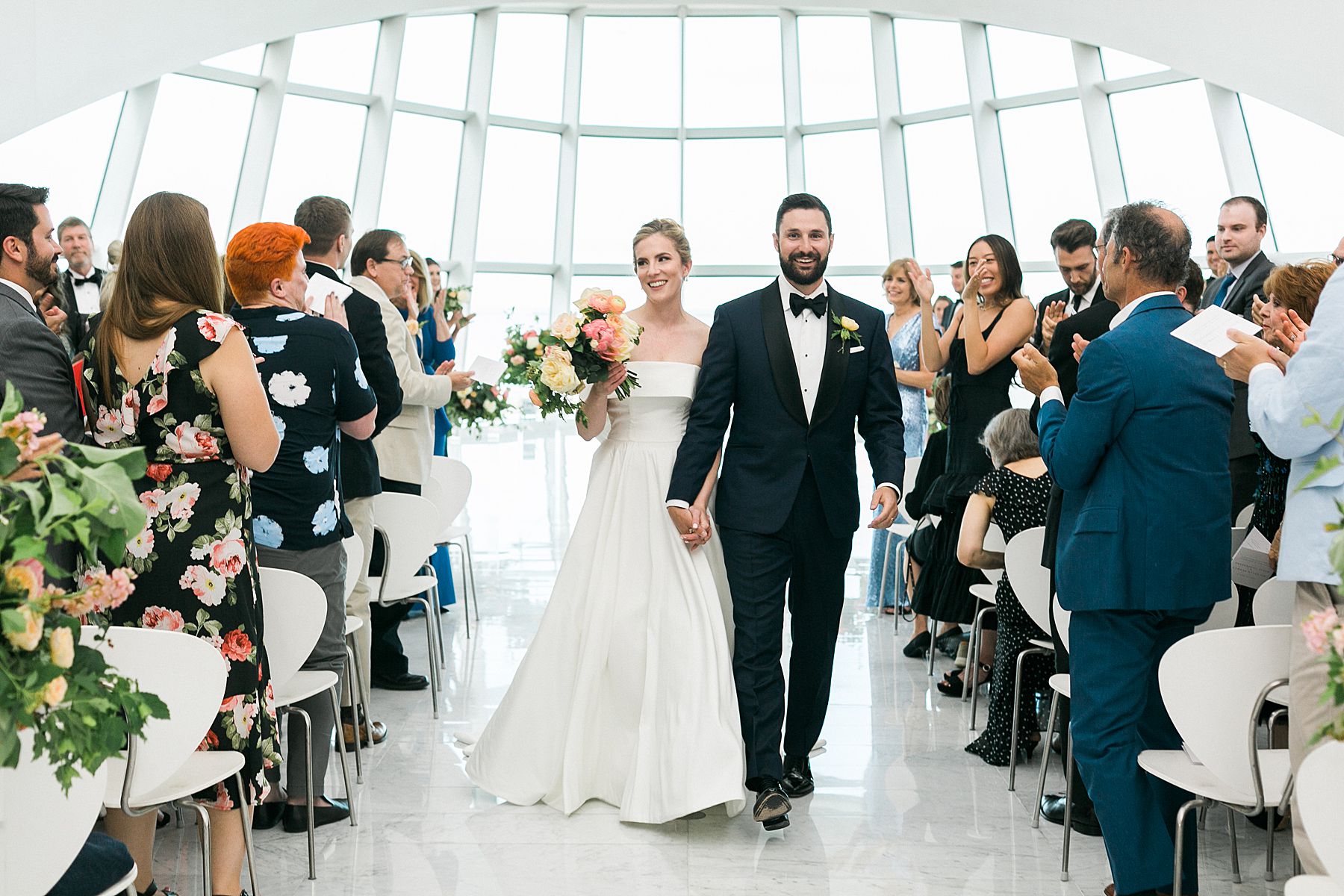 newlywed wedding exit, modern minimal white and bright wedding ceremony at milwaukee art museum an architectural gem downtown with lake michigan view