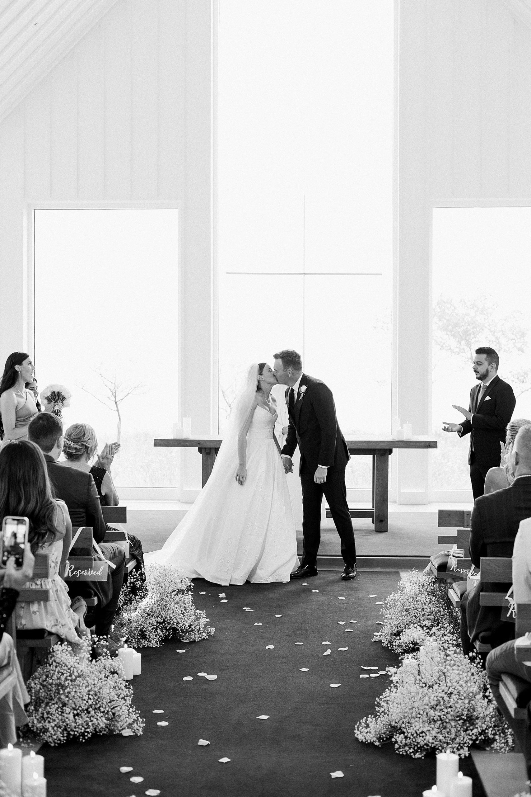 newlywed first kiss bride and groom wedding ceremony at straits chapel in kohler wisconsin