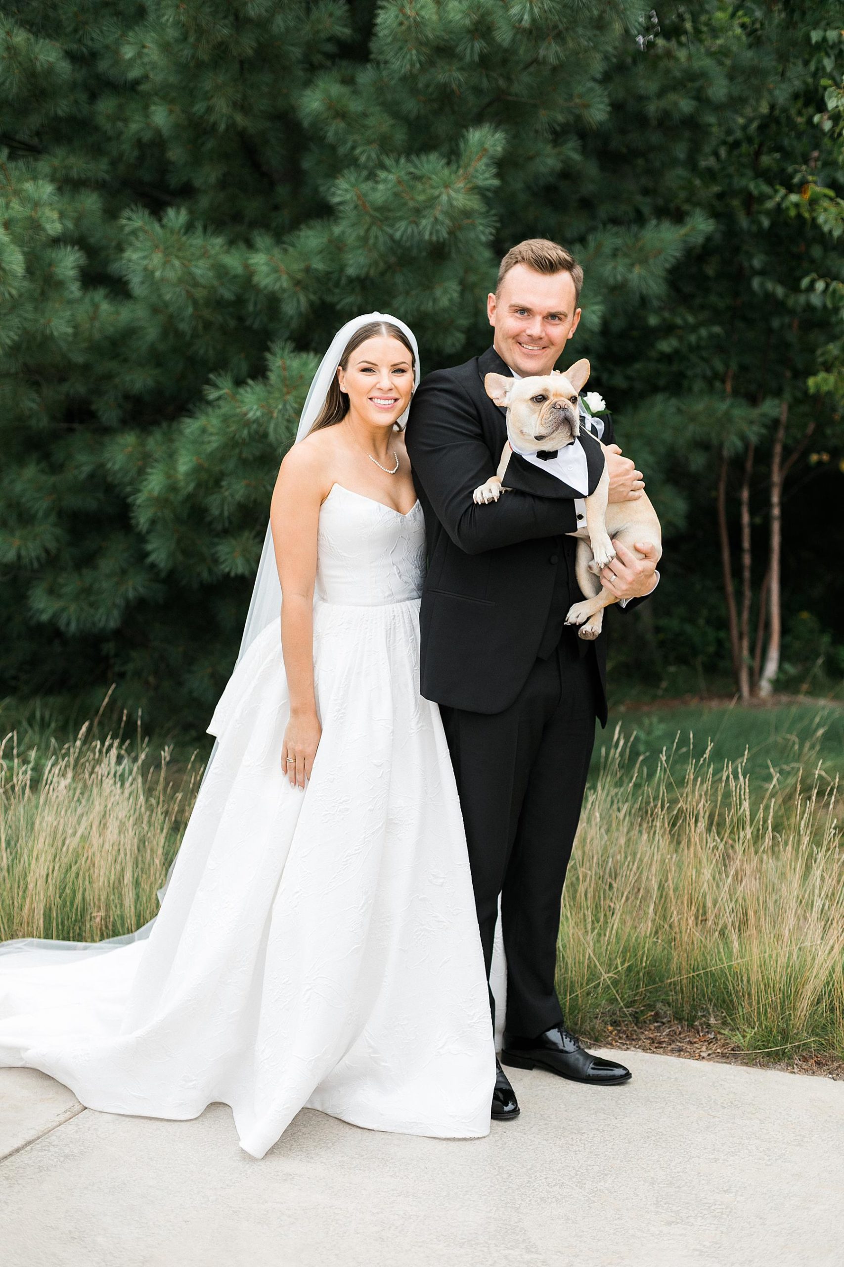 newlywed couples portrait bride and groom with dog at straits chapel in kohler wisconsin