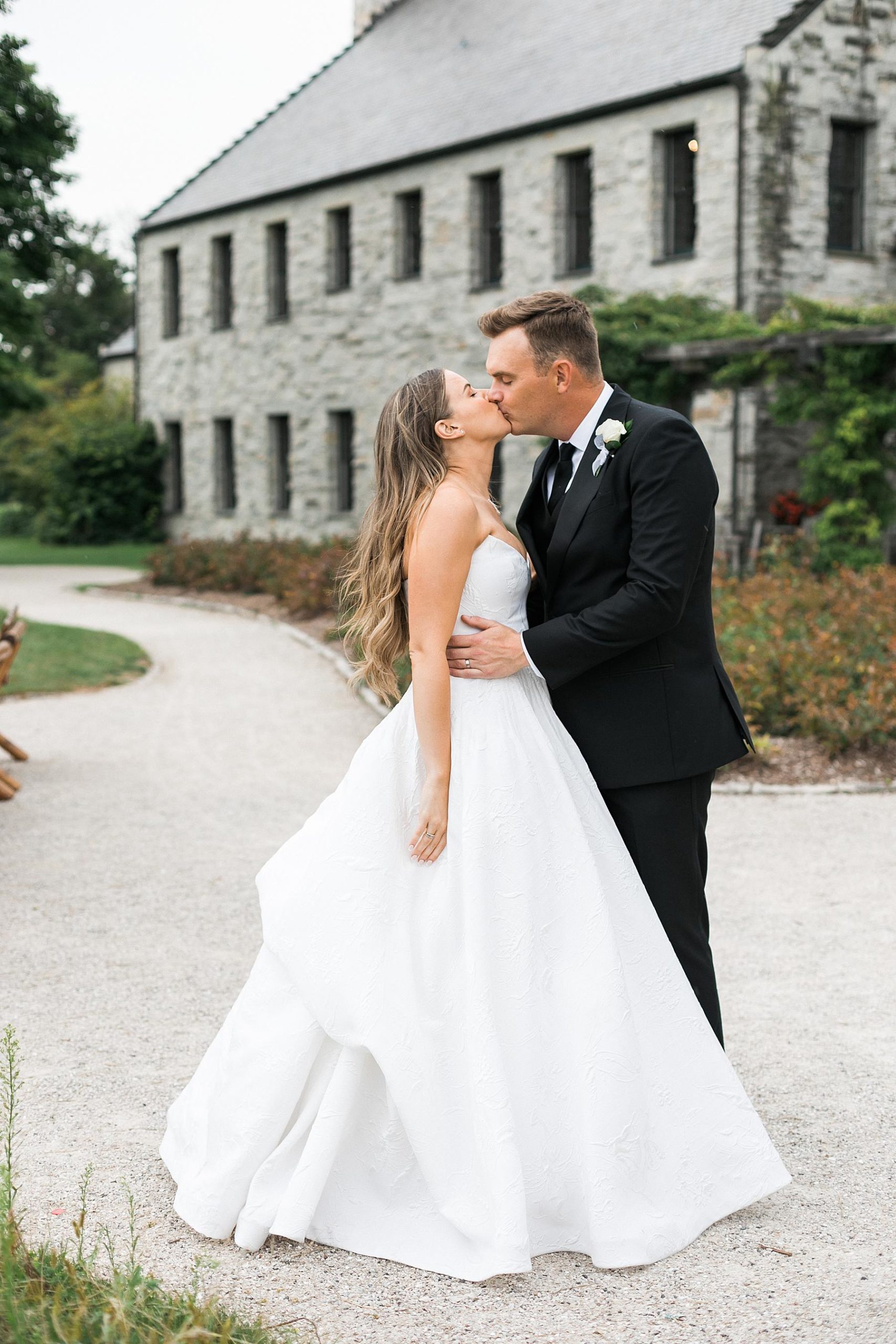 newlywed kiss couples portrait bride and groom at irish barn at whistling straits in kohler wisconsin