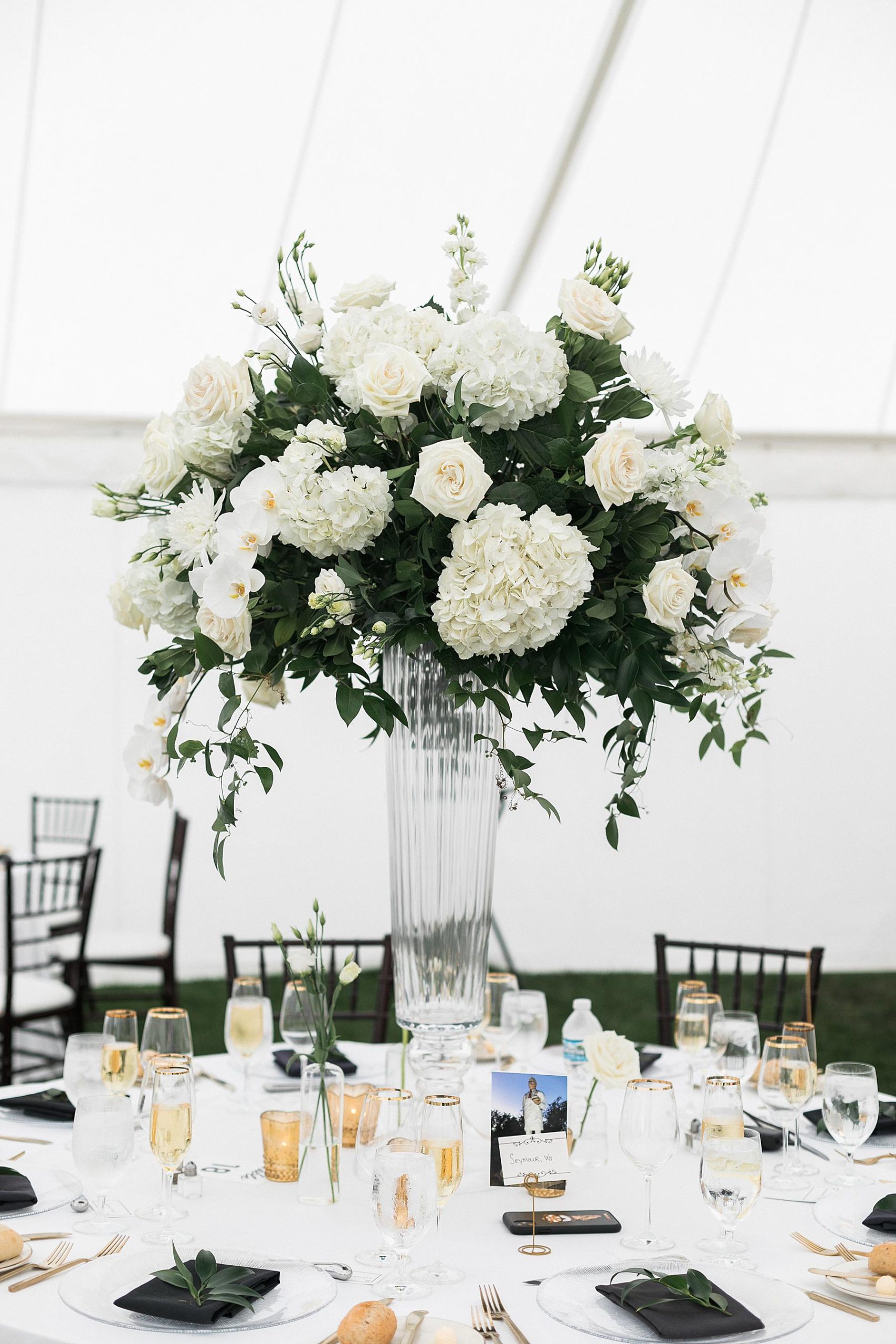 white flower table arrangement at sailcloth tent wedding reception at horseshoe bay beach club in door county