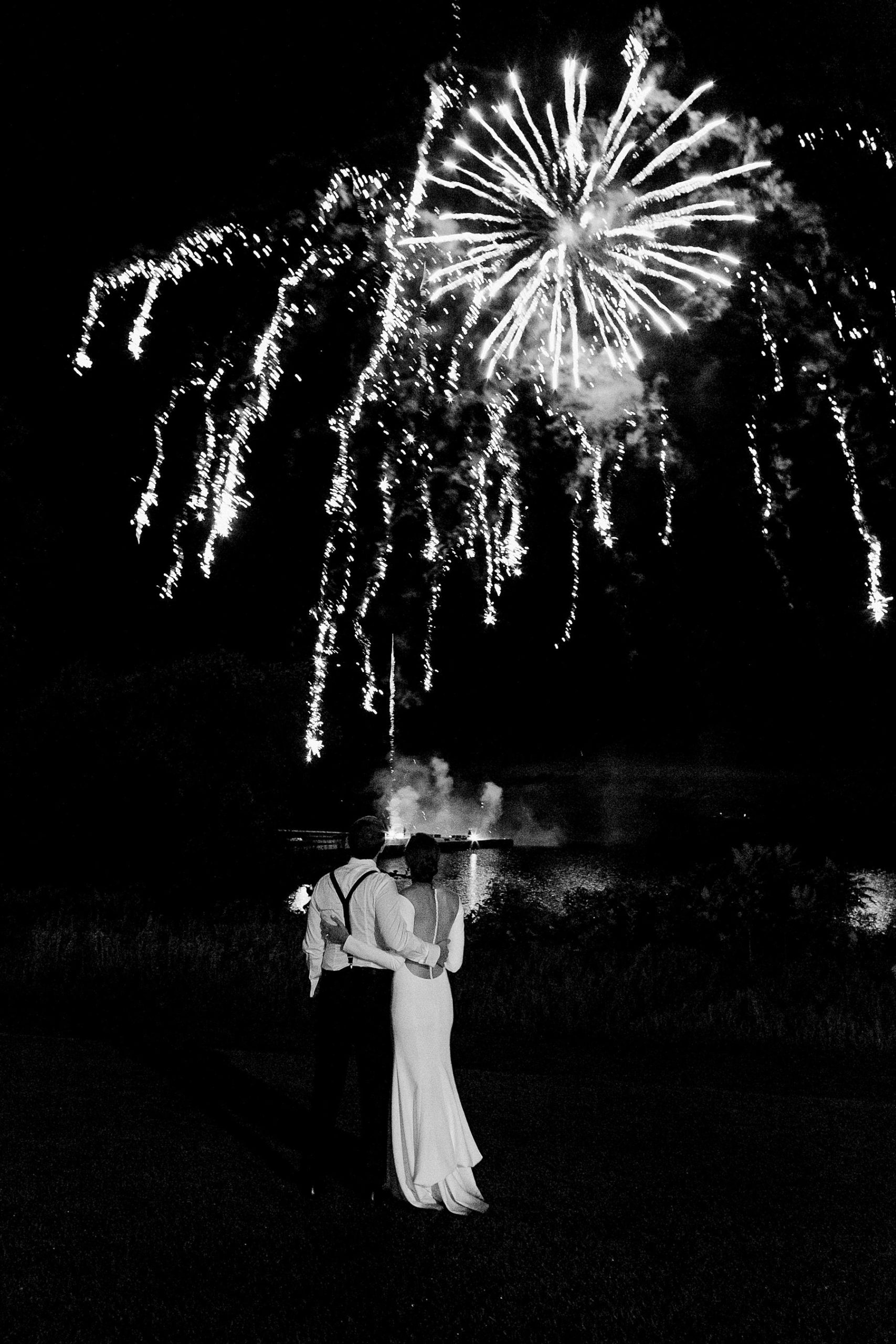 fireworks bride and groom sunset portrait on a rainy day at horseshoe bay beach club in door county in wisconsin