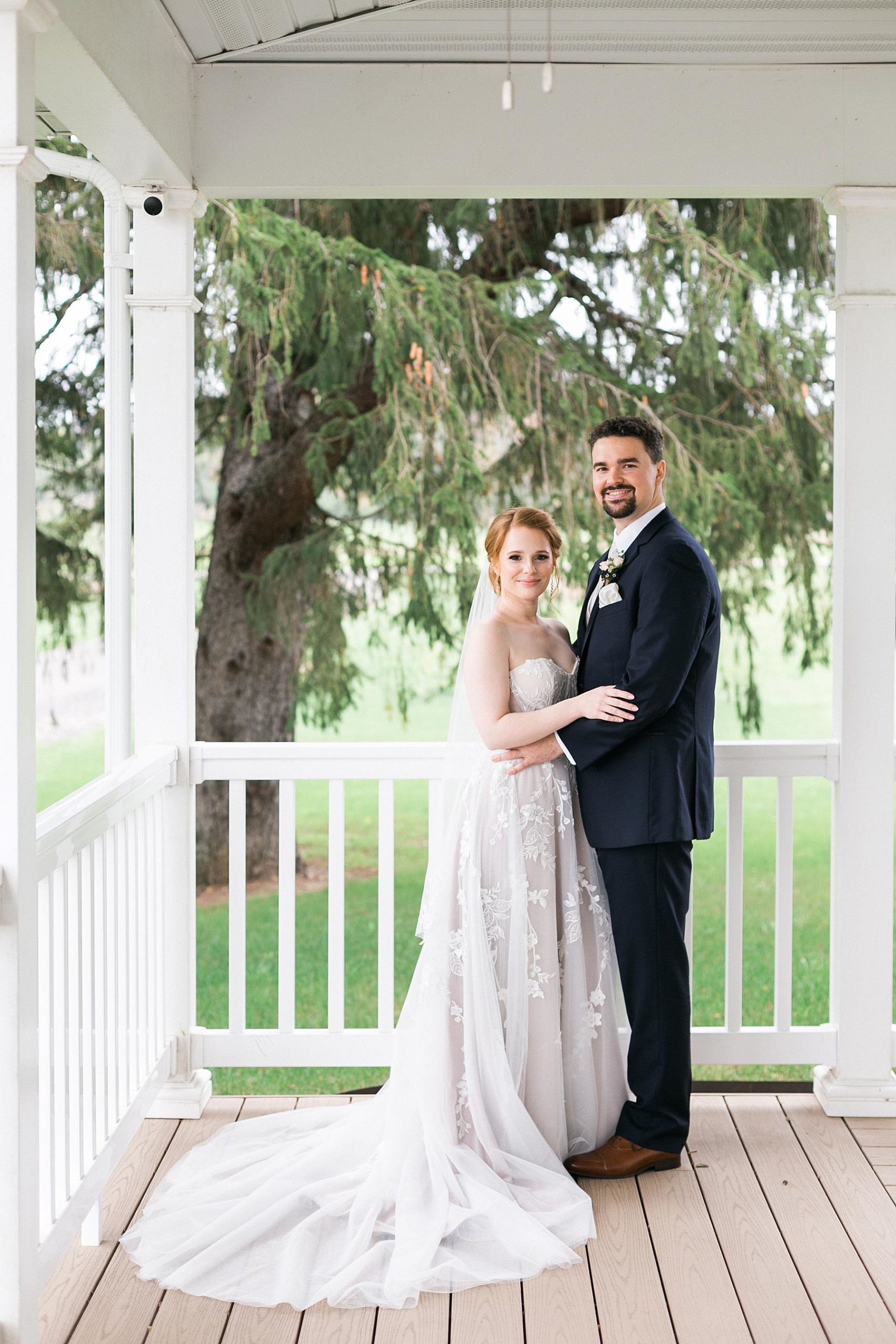 bride and groom on farmhouse front porch