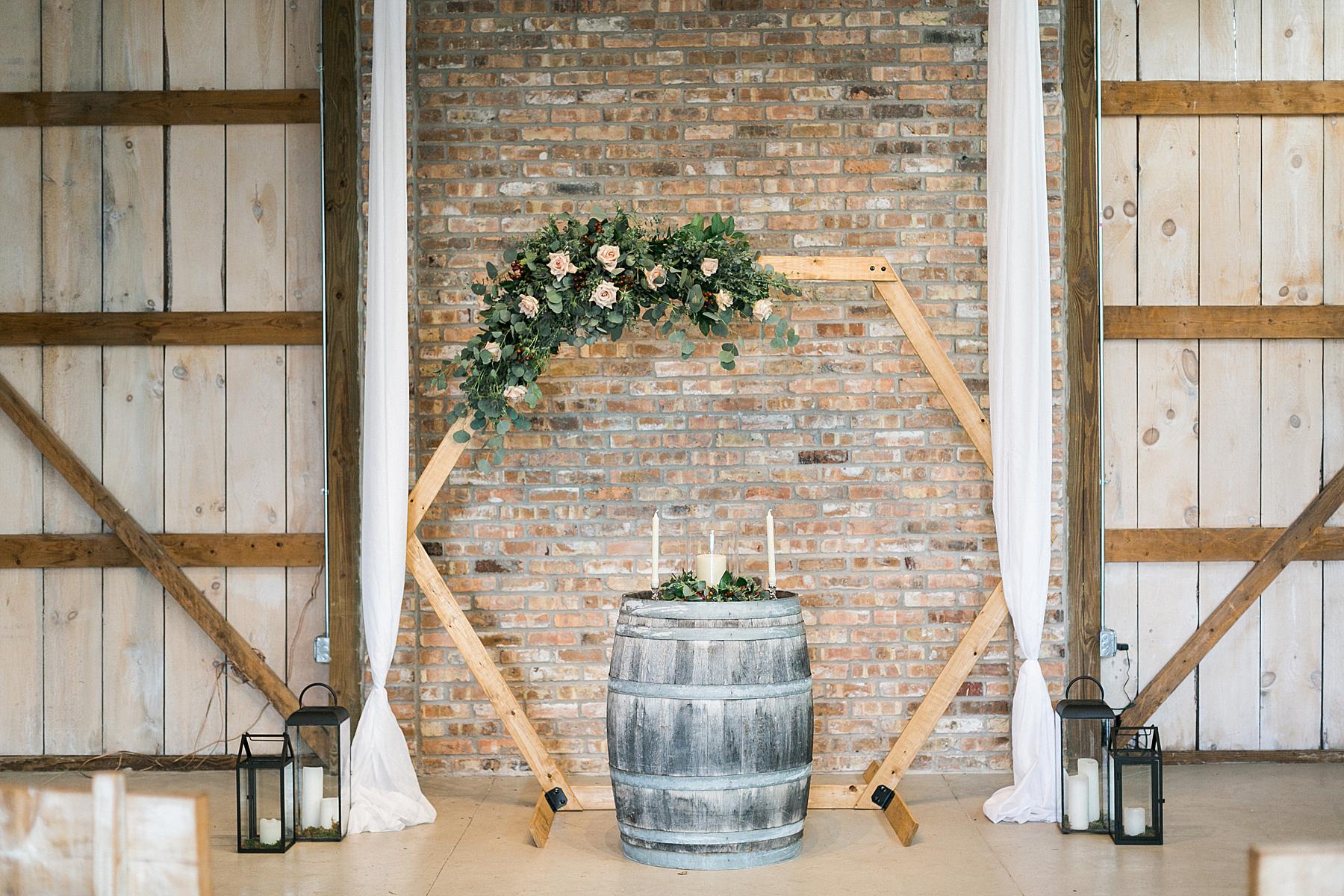 ceremony backdrop for indoor barn wedding at lilac acres in milwaukee, wisconsin