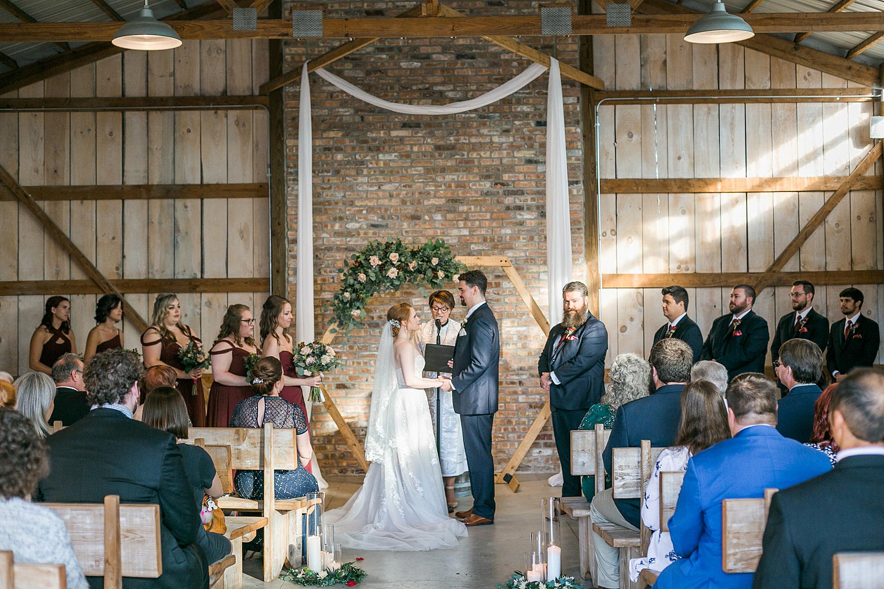 indoor barn wedding ceremony at lilac acres in milwaukee, wisconsin