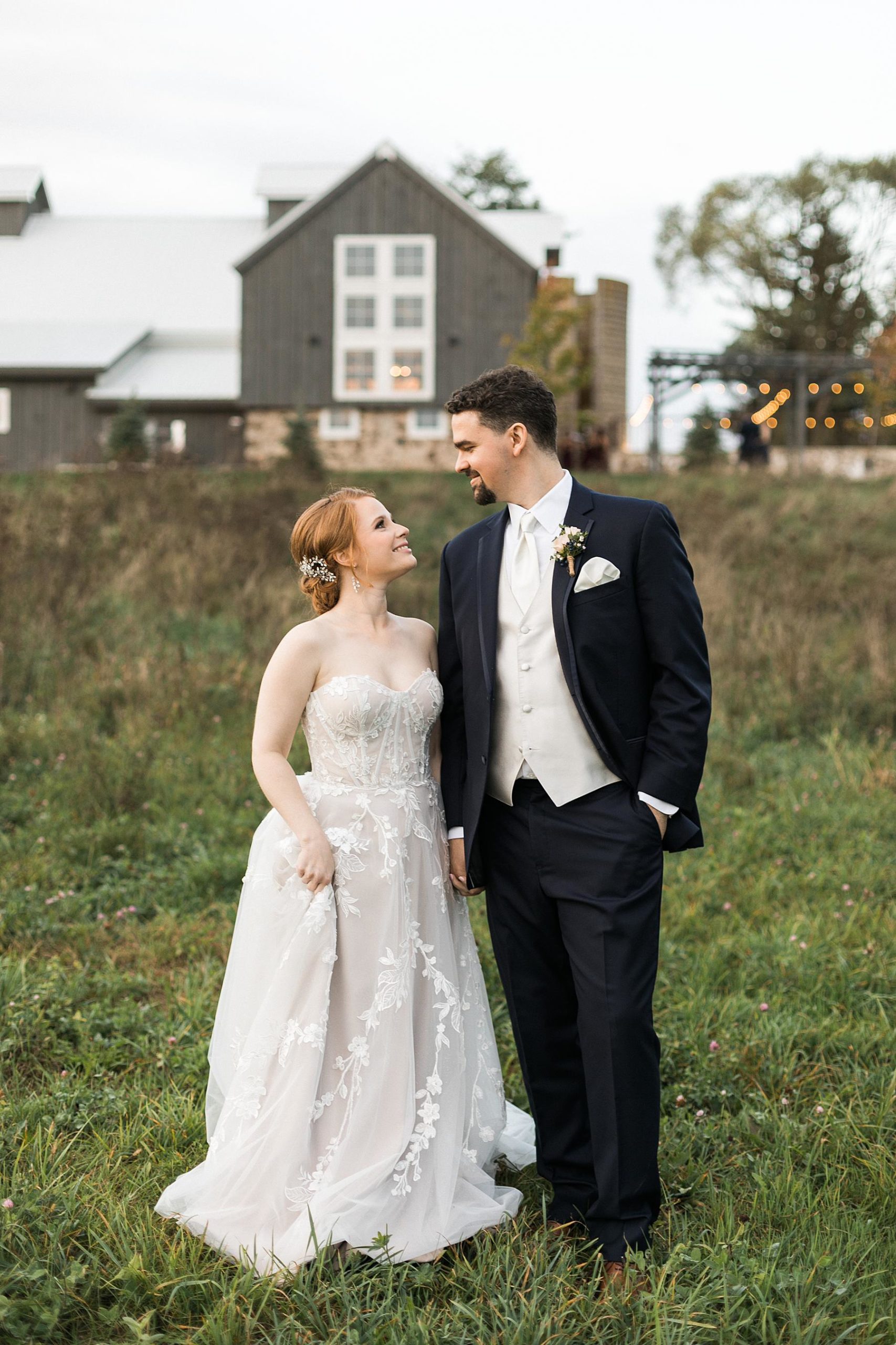 bride and groom couple sunset portrait in front of barn for fall wedding at lilac acres in milwaukee wisconsin