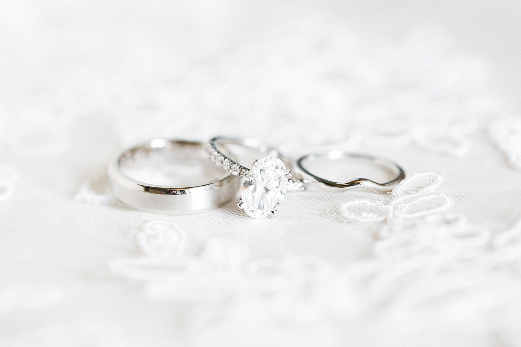 wedding bands rings on white lace wedding dress