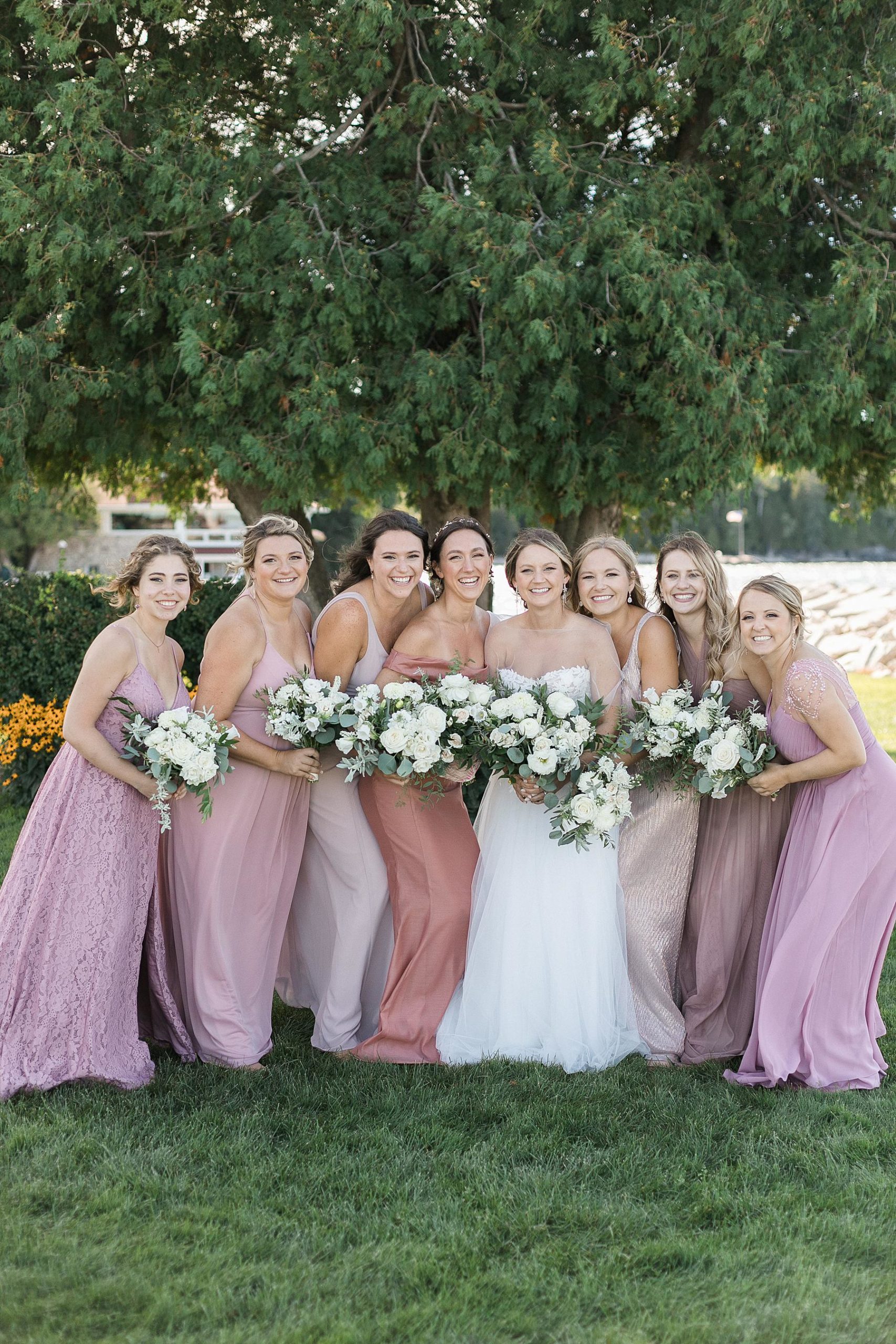 bridesmaid photo in pink and mauve dresses at gordon lodge in baileys harbor door county