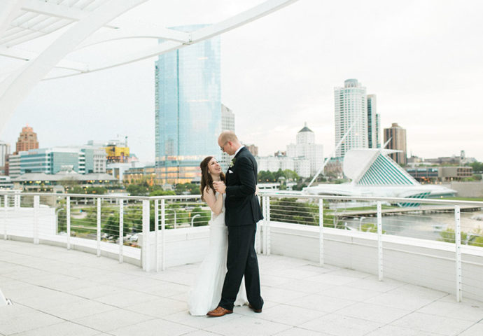sunset skyline bride and groom portrait, discovery world downtown milwaukee wisconsin, organic romantic elegant + modern city wedding day, greenery blue and neutrals, photo by laurelyn savannah photography