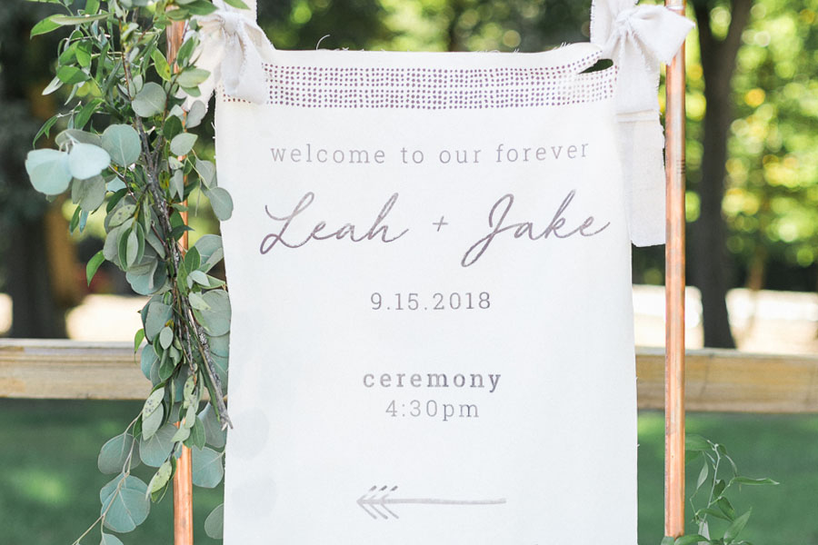 signage on canvas linen, glamping and chic safari romantic outdoor wedding at Milwaukee County Zoo, Wisconsin, photo by Laurelyn Savannah Photography