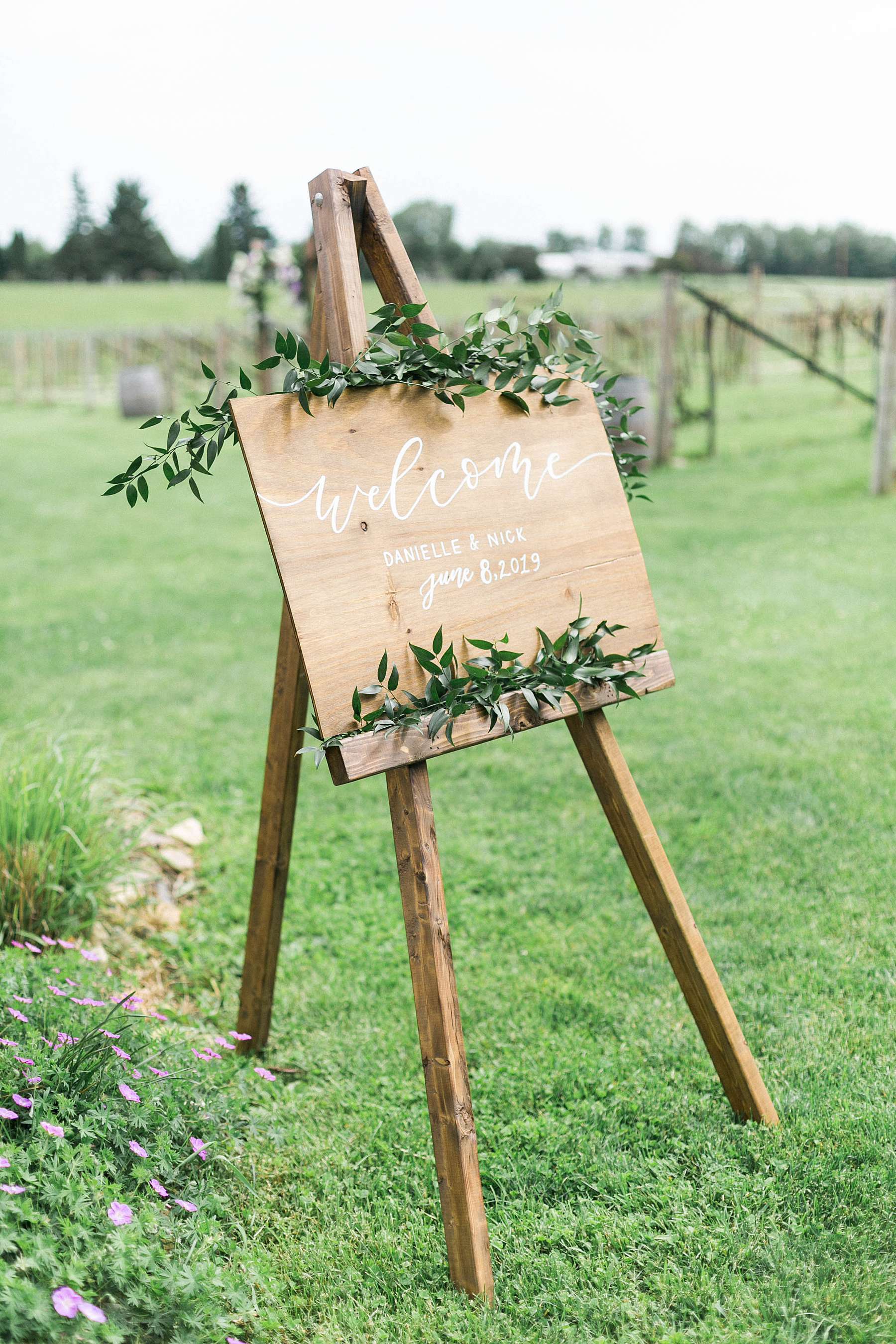 wooden wedding sign with calligraphy, rustic romantic wedding at over the vines with midwestern bride, photo by laurelyn savannah photography