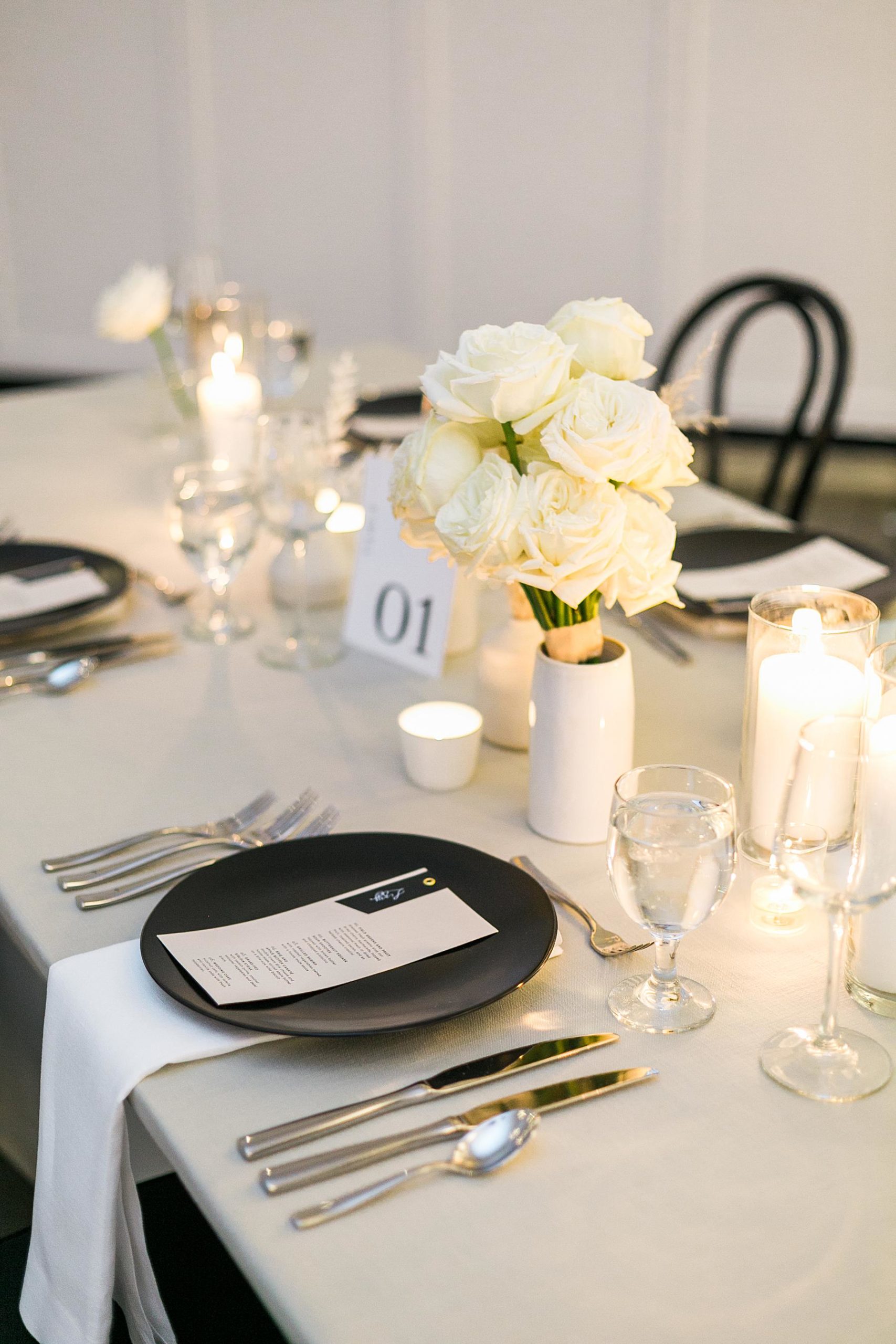 candles and black and white elegant boho reception table decor at hutton house wedding venue in minneapolis minnesota