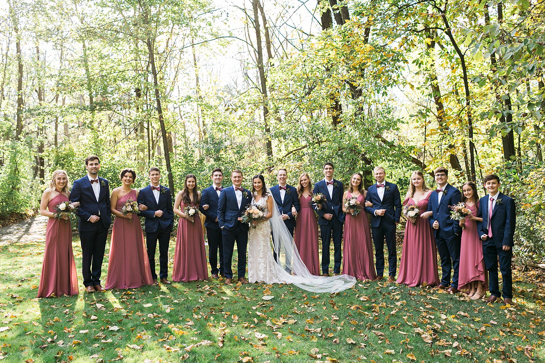 bridal party portraits fall autumn wedding with bridal party in mauve and navy blue