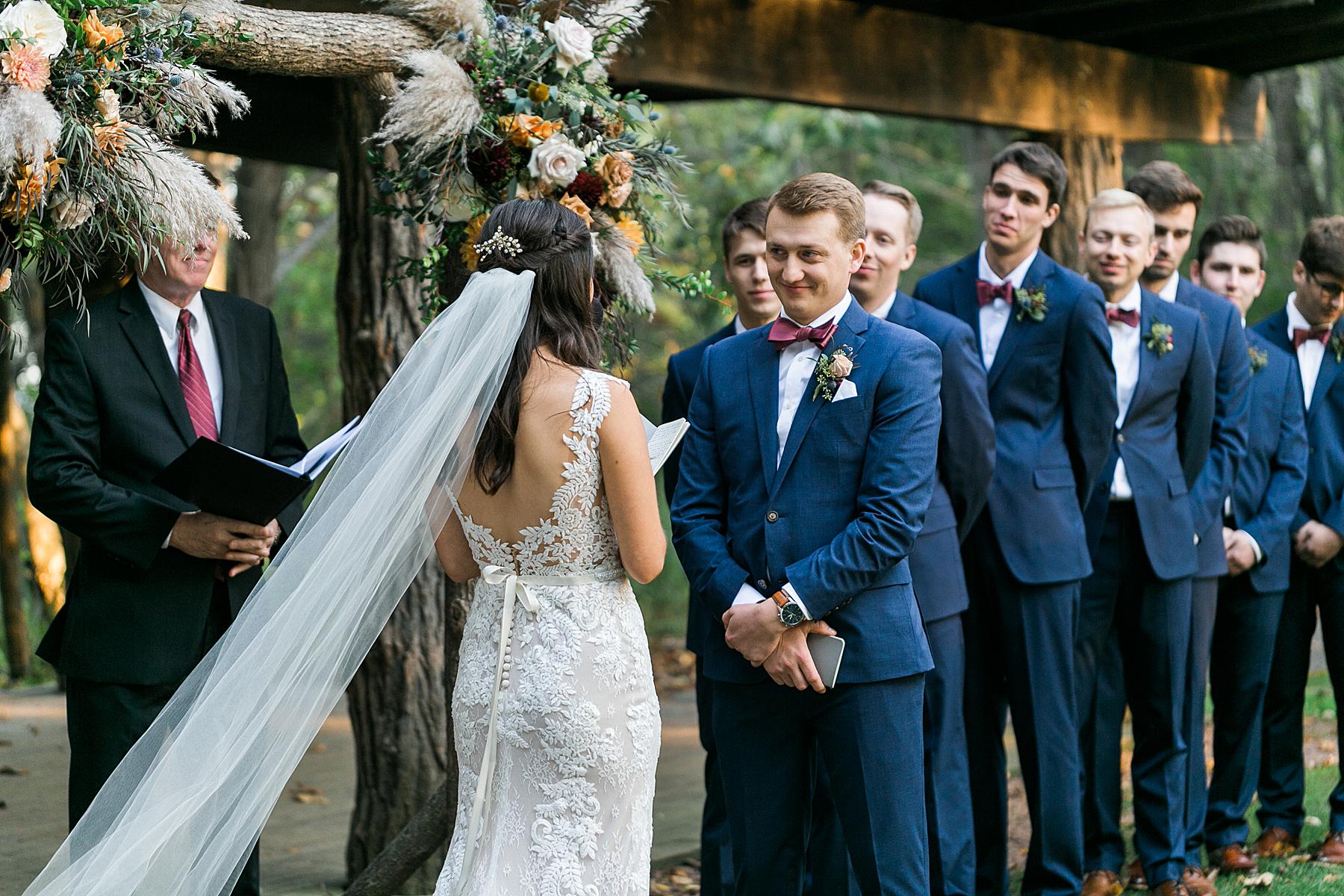 fall outdoor wedding ceremony at schlitz audubon nature center in milwaukee, wi
