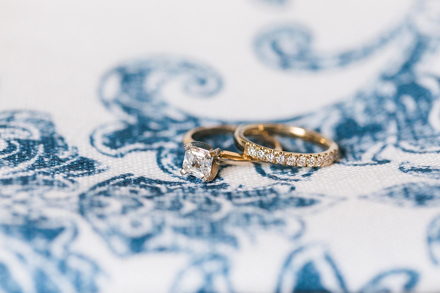wedding rings bands on blue brocade floral table linen, fields reserve near madison, wisconsin